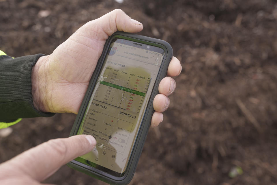 Republic Services' Otay Compost facility operation supervisor Dana Armstrong checks remote data of active heaps being processed at the Otay Compost facility in Chula Vista, Calif., on Friday, Jan. 26, 2024. Two years after California launched an effort to keep organic waste out of landfills, the state is so far behind on getting food recycling programs up and running that it's widely accepted next year's ambitious waste-reduction targets won't be met. (AP Photo/Damian Dovarganes)