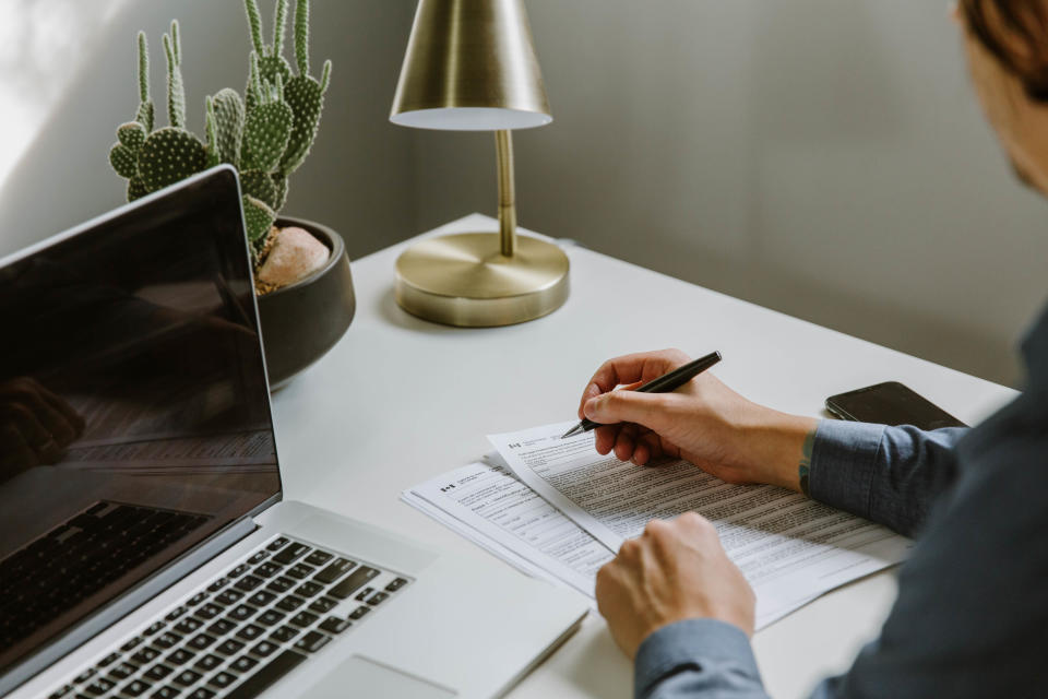 Young professional male filling out tax documents