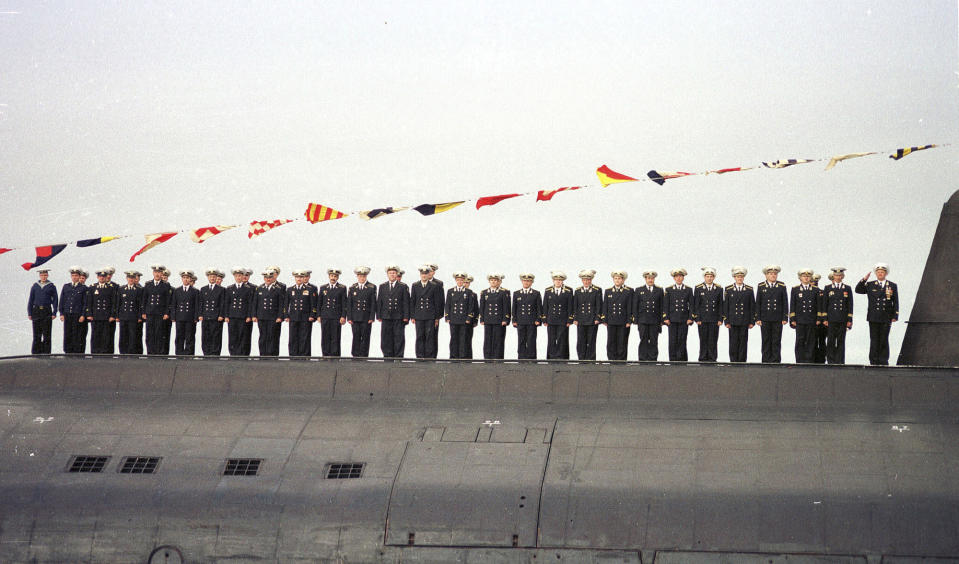FILE - Crew members of the Russian nuclear submarine Kursk stand on its deck during a naval parade in Severomorsk, Russia, on July 30, 2000. The Kursk submarine sinks with 118 people aboard, setting off the first widespread and sustained criticism of Putin, who remained on vacation early in the crisis and waited five days before accepting Western offers of help. (AP Photo, File)