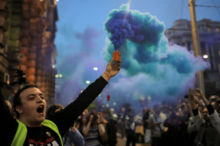 A protester lights a flare during a protest against Prime Minister Aleksandar Vucic's government in Belgrade, Serbia April 25, 2017. REUTERS/Marko Djurica