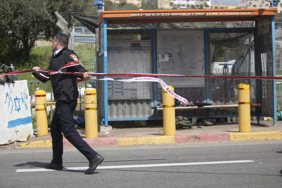 An Israeli police officer is seen at the scene of an attack near the West Bank Jewish settlement of Ariel, Sunday, March 17, 2019.The Israeli military says a Palestinian killed an Israeli and seriously wounded two others in a West Bank shooting and stabbing spree before fleeing and setting off a massive manhunt. (AP Photo/Sebastian Scheiner)