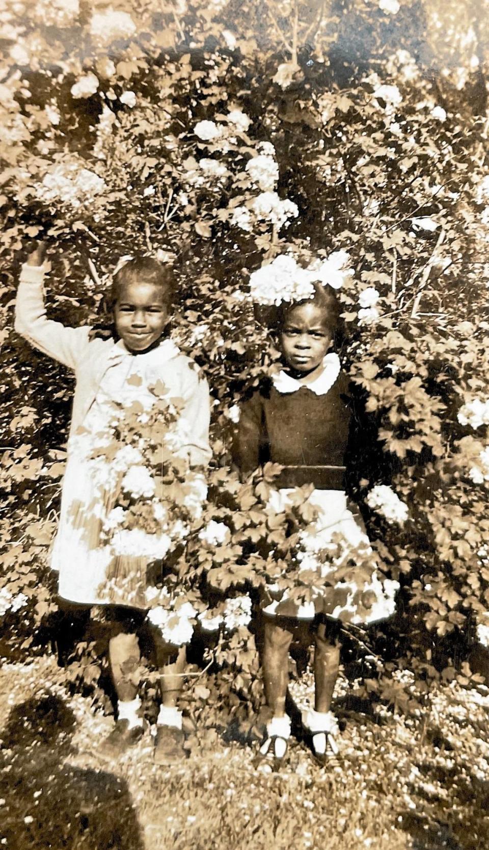 Cousins Georgia Bradsher and Dolores Clark pose together near their homes in Carrboro, N.C. in this family photograph.