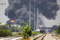 Smoke billows from a tank fire at the Marathon Petroleum facility in Garyville, La., Friday, Aug. 25, 2023. Garyville is located about 40 miles up the Mississippi River from New Orleans. (Chris Granger/The Times-Picayune/The New Orleans Advocate via AP)