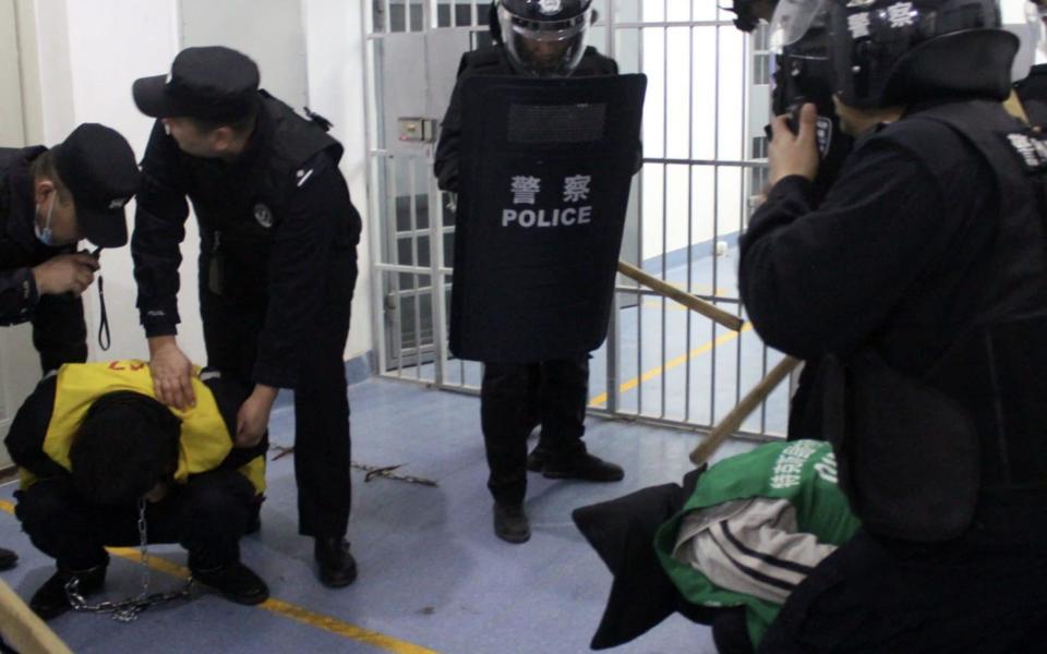 A Uyghur chained by military officials - Adrian Zenz