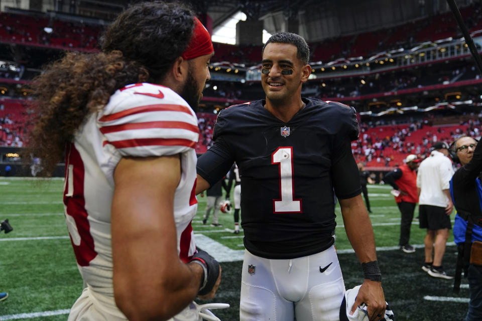 Atlanta Falcons quarterback Marcus Mariota (1) speaks to San Francisco 49ers safety Talanoa Hufanga (29) after an NFL football game, Sunday, Oct. 16, 2022, in Atlanta. The Atlanta Falcons won 28-14. (AP Photo/Brynn Anderson)