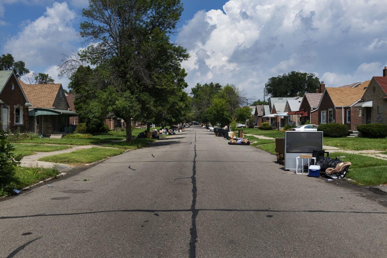 Detroit, Michigan, USA - August 20, 2014: A suburban street with houses being evicted and people belongings on the lawns near the 8 mile road, in the city of Detroit.