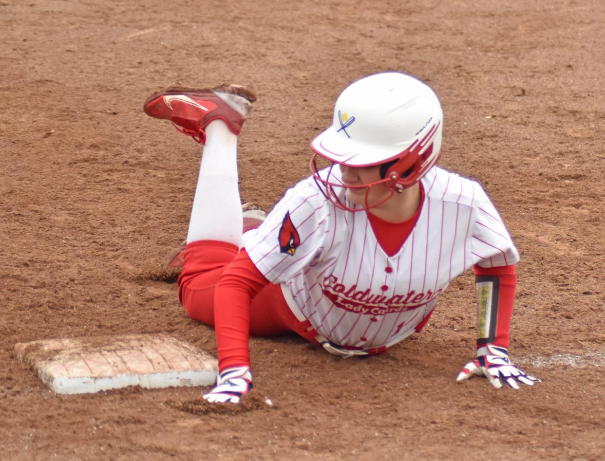 Coldwater's Brooklyn Closson slides safely back to first on a pick off attempt by the catcher on Tuesday versus Marshall