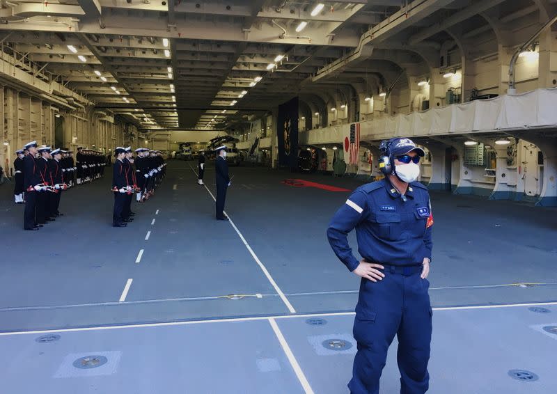 Japan Maritime Self-Defense Force soldiers wearing protective masks are seen on board of the helicopter destroyer JS Kaga during Keen Sword, at mid-sea off south of Japan