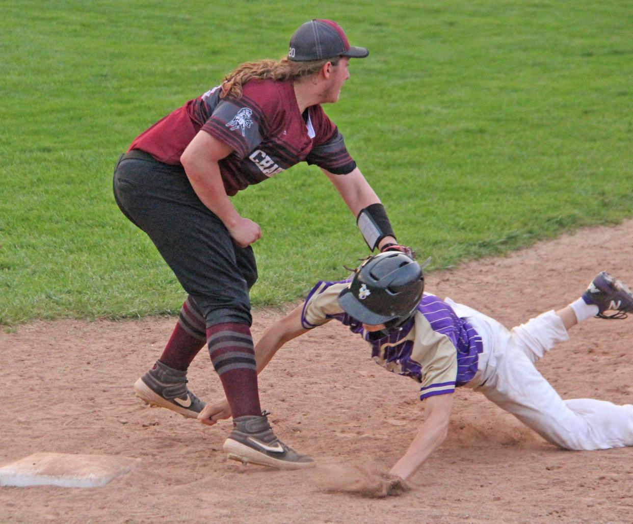 Union City's Phoenix Elkins applies the tag on a successful pick off attempt of a Concord runner Tuesday night