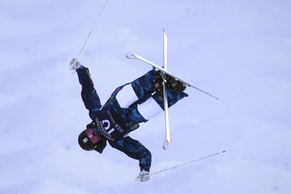 FILE - United States' Kai Owens flies over a jump during the World Cup women's freestyle moguls skiing competition Thursday, Feb. 4, 2021, in Deer Valley, Utah. As an infant, she was abandoned at a town square in a province of China. Taken to an orphanage, she was adopted by a couple from Colorado at 16 months. Now 17, U.S. freestyle skier Kai Owens is on the verge of earning a spot in moguls for the Winter Games in Beijing. It's a return to China she's long thought about. (AP Photo/Rick Bowmer, File)