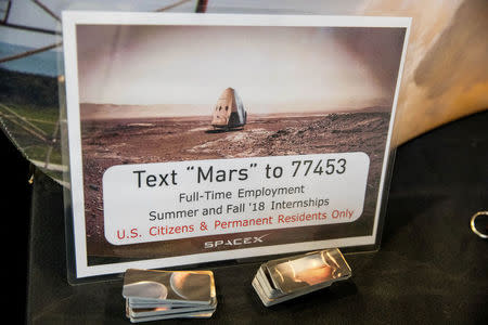 FILE PHOTO: A poster showing a Mars lander is seen at a job recruiting booth for SpaceX at TechFair in Los Angeles, California, U.S. March 8, 2018. REUTERS/Monica Almeida/File Photo