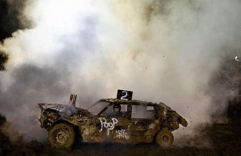 Smoke fills the air as it pours out of the car of Tyler Smith (2 car), of Tarlton, during the Demolition Derby at the grandstand at the Fairfield County Fair in Lancaster, Ohio on October 15, 2021.