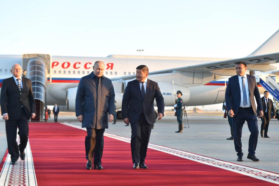 Chairman of the Cabinet of Ministers of Kyrgyzstan Akylbek Zhaparov (centre right) walking with Russia's President Vladimir Putin (centre left) upon his arrival at the Manas International Airport in Bishkek (CABINET OF MINISTERS OF KYRGYZST)