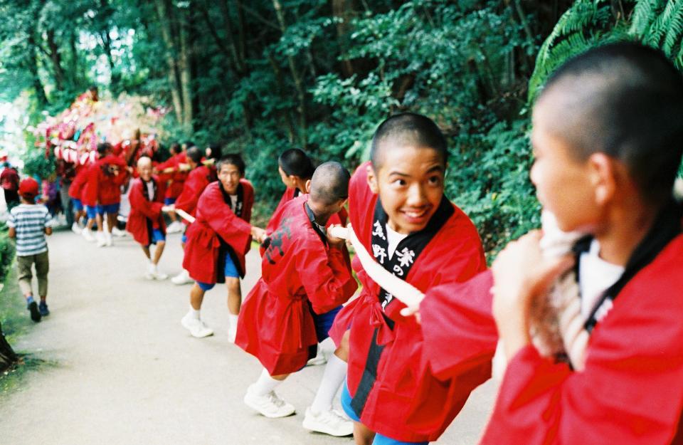 A portable shrine called a “fune,” or ship, is pulled to the top of the mountain by male students from the high school.