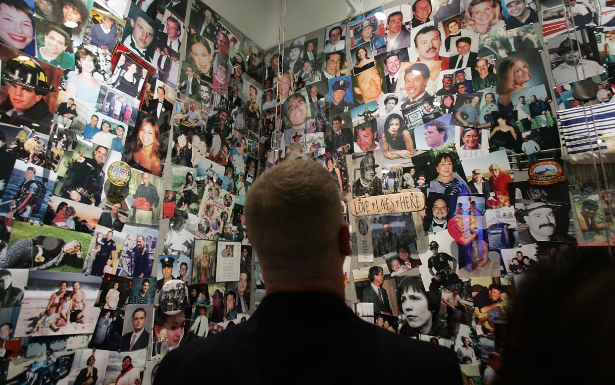 A firefighter looks at photos of 9/11 victims 