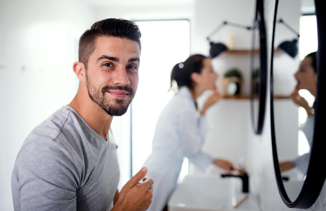 Young man and woman doing morning routine.