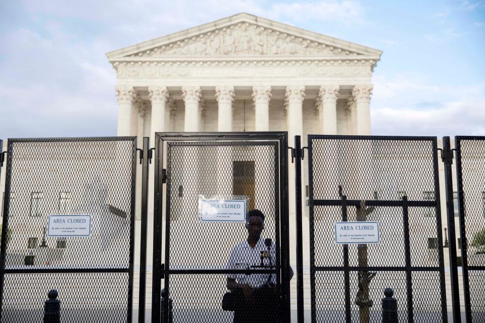 A police officer stands by a fence during an abortion rights protest led by the Party for Socialism and Liberation in front of the Supreme Court in Washington on Wednesday, May 11, 2022.