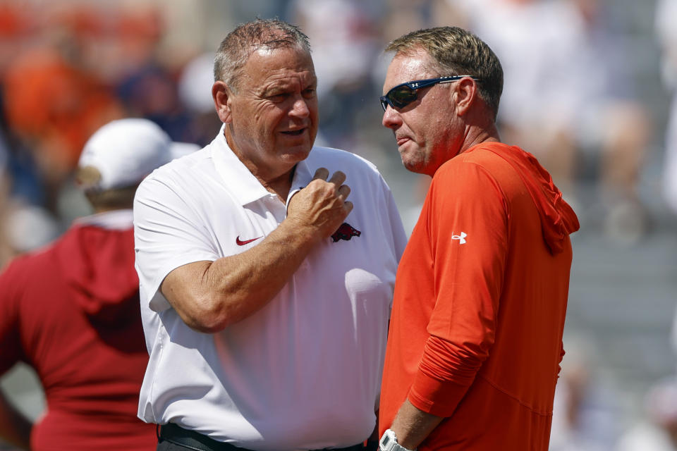 Arkansas head coach Sam Pittman, left, and Auburn head coach Hugh Freeze, right, talk before an NCAA college football game, Saturday, Sept. 21, 2024, in Auburn, Ala.(AP Photo/Butch Dill)