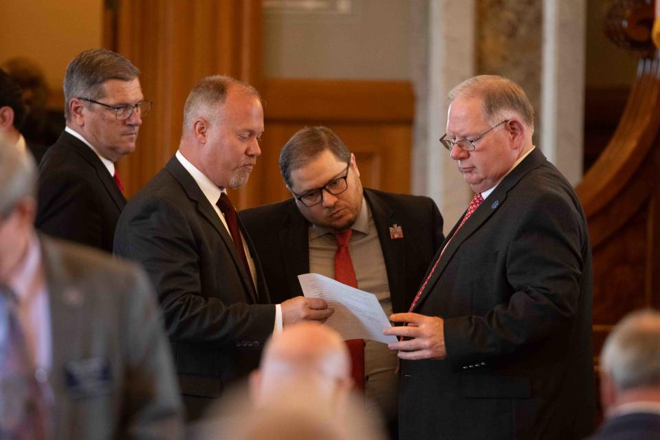 House GOP leaders review a proposed amendment to a tax cut bill put forth by Rep. Vic Miller, D-Topeka, Tuesday.