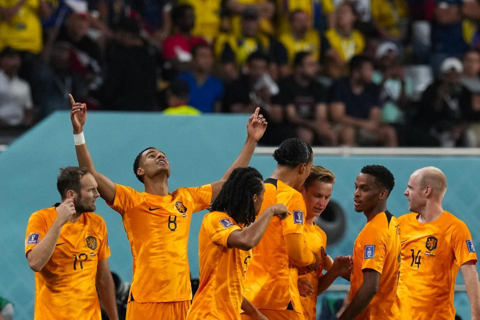 Cody Gakpo of the Netherlands, second left, celebrates after scoring the opening goal during the World Cup group A football match between Netherlands and Ecuador, at the Khalifa International Stadium in Doha, Qatar, Friday, Nov. 25, 2022. (AP Photo/Themba Hadebe)