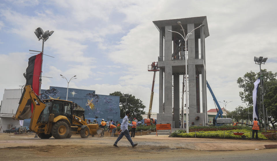 Workers ready a new monument, called the Peace Bell, before its inauguration ceremony later in the day in Managua, Nicaragua, Friday, July 17, 2020. Nicaraguan President Daniel Ortega's government is being deterred by the new coronavirus from holding the usual mass celebration to mark the victory of the country's revolution July 19, so will instead unveil a new addition to its collection of monuments. (AP Photo/Alfredo Zuniga)