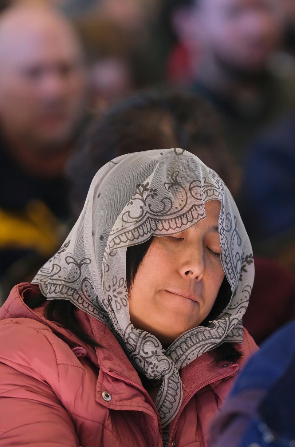 A woman prays Friday at the Mass for the Dedication of a Church and Altar at the Blessed Stanley Rother Shrine.