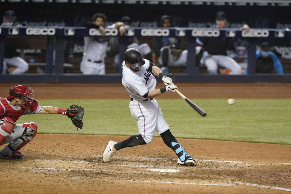 Miami Marlins' Jon Berti hits a single scoring Adam Duvall and Isan Diaz during the eighth inning of a baseball game against the Philadelphia Phillies, Wednesday, May 26, 2021, in Miami. (AP Photo/Wilfredo Lee)