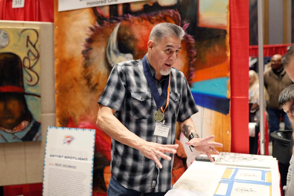 Red Earth Honored One Brent Greenwood speaks to people at his booth during the Red Earth Festival at the National Cowboy & Western Heritage Museum in Oklahoma City, Friday, March 22, 2024.