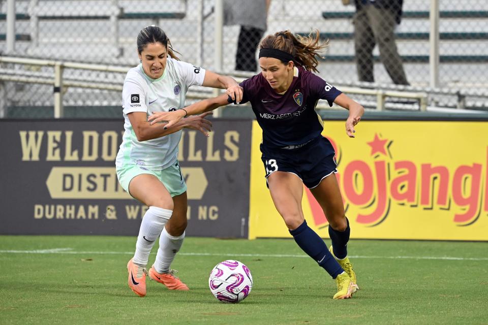 Sep 9, 2023; Cary, North Carolina, USA; North Carolina Courage defender Ryan Williams (13) and Racing Louisville FC midfielder Savannah DeMelo (7) battle for the ball in the first half at WakeMed Soccer Park. Mandatory Credit: Bob Donnan-USA TODAY Sports
