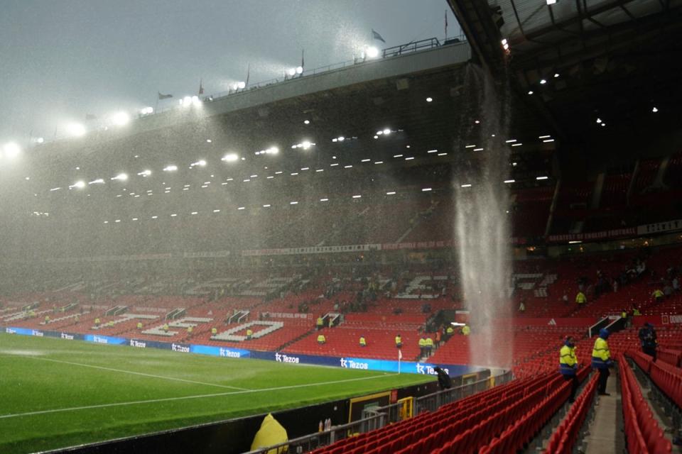 The rain comes down from the roof at the Old Trafford stadium at the end of the match (AP)