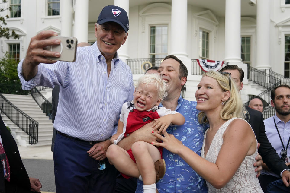 President Joe Biden poses for a photo with guests at the Congressional Picnic on the South Lawn of the White House, Tuesday, July 12, 2022, in Washington. (AP Photo/Patrick Semansky)