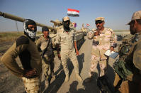 <p>Iraqi forces discuss military tactics as they drive towards Kurdish peshmerga positions on the southern outskirts of Kirkuk on Oct. 15, 2017. (Photo: Ahmad Al-Rubaye/AFP/Getty Images) </p>