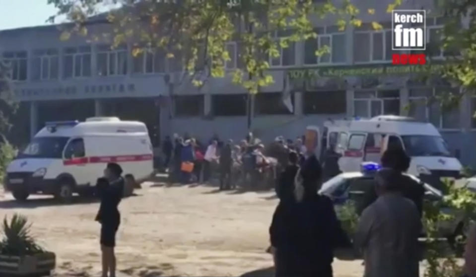 RETRANSMISSION TO CORRECT TO SHOOTING NOT EXPLOSION - In this image made from video, showing the scene as emergency services load an injured person onto a truck, in Kerch, Crimea, Wednesday Oct. 17, 2018. An 18-year-old student strode into his vocational school in Crimea, a hoodie covering his blond hair, then pulled out a shotgun and opened fire on Wednesday, killing 19 students and wounding more than 50 others before killing himself.(Kerch FM News via AP) KERCH.FM LOGO CANNOT BE OBSCURED