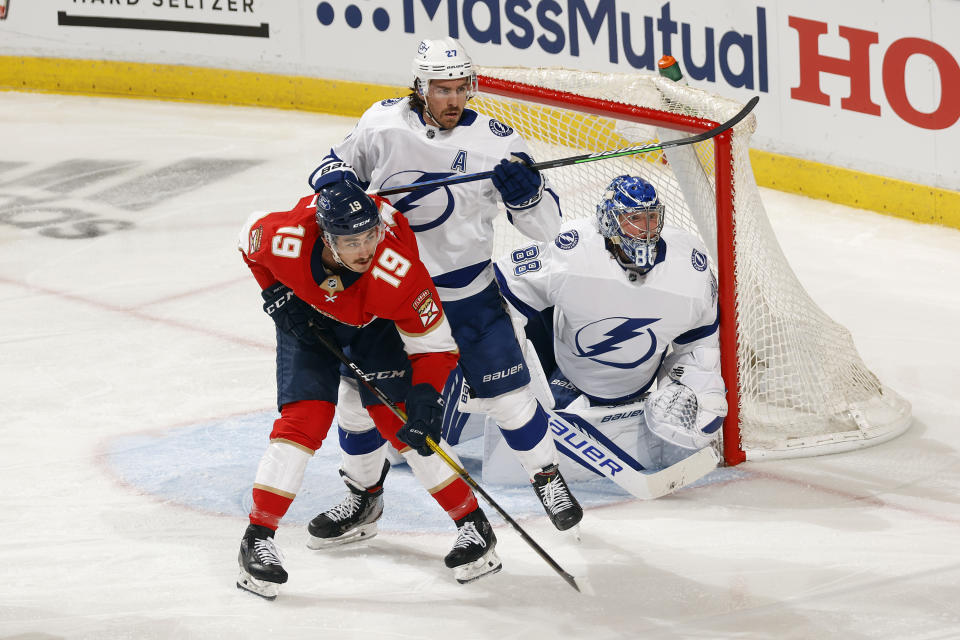 Tampa Bay Lightning defenseman Ryan McDonagh (27) defends against Florida Panthers left wing Mason Marchment (19) in front of Tampa Bay Lightning goaltender Andrei Vasilevskiy (88) during the second period in Game 1 of an NHL hockey Stanley Cup first-round playoff series, Sunday, May 16, 2021, in Sunrise, Fla. (AP Photo/Joel Auerbach)