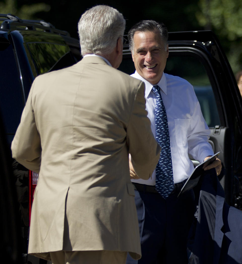 Republican presidential candidate, former Massachusetts Gov. Mitt Romney, right, greets a bystander before entering the Church of Jesus Christ of Latter-day Saints on Sunday, Aug. 19, 2012, in Wolefboro, N.H. (AP Photo/Evan Vucci)