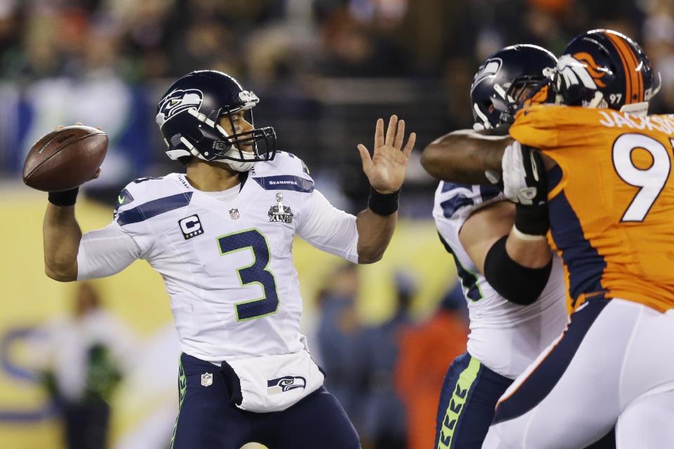 Seattle Seahawks' Russell Wilson (3) throws against the Denver Broncos during the first half of the NFL Super Bowl XLVIII football game Sunday, Feb. 2, 2014, in East Rutherford, N.J. (AP Photo/Julio Cortez)