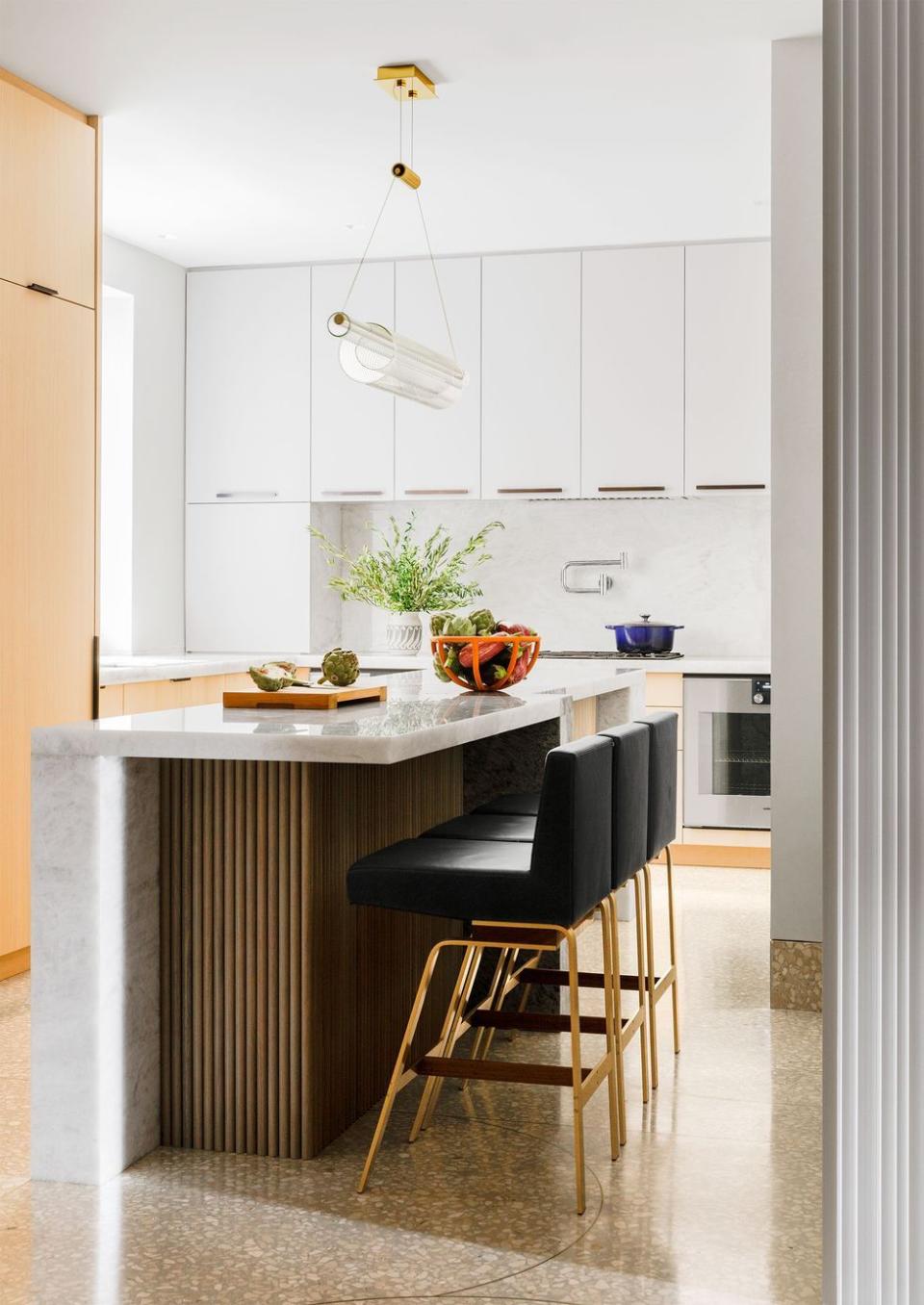 a kitchen with a black chair