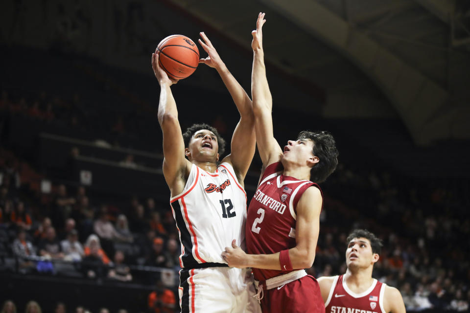 Oregon State forward Michael Rataj (12) drives to the basket as Stanford guard Andrej Stojakovic (2) defends during the first half of an NCAA college basketball game Thursday, Jan. 11, 2024, in Corvallis, Ore. (AP Photo/Amanda Loman)