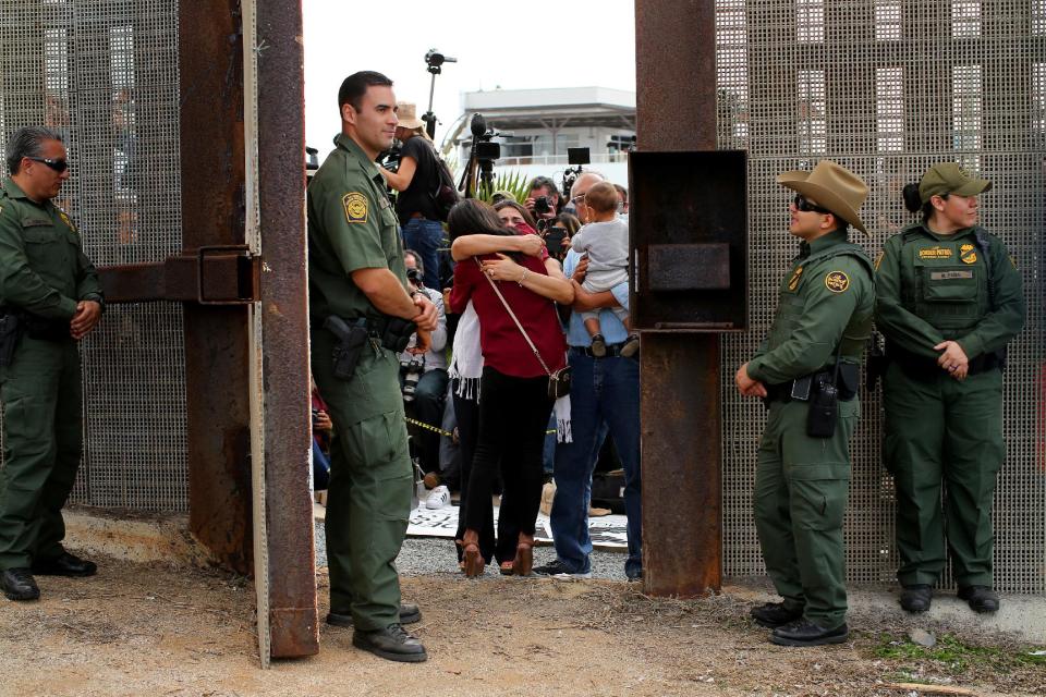 FILE PHOTO - U.S. Border patrol agents stand watch at an open gate on the fence along the Mexico border to allow Delia Valdovinos-Sanchez to embrace Ramona Vargas, as part of Universal Children's Day at the Border Field State Park, California, U.S. on November 19, 2016. REUTERS/Mike Blake/File Photo