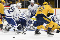 Toronto Maple Leafs center Noel Acciari (52) looks for the puck as Nashville Predators center Tommy Novak (82) defends during the second period of an NHL hockey game Sunday, March 26, 2023, in Nashville, Tenn. (AP Photo/Mark Zaleski)