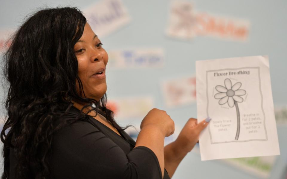 Early childhood mental health consultant Nashaylia Jenkins presents a method to help children control their breathing during a workshop Monday, April 10, 2023, for teachers at Bright Beginnings Preschool in Sarasota. 