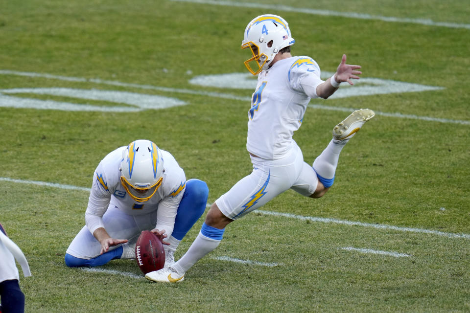 Los Angeles Chargers kicker Mike Badgley (4) kicks a field goal as punter Ty Long holds during the first half of an NFL football game against the Denver Broncos, Sunday, Nov. 1, 2020, in Denver. (AP Photo/Jack Dempsey)