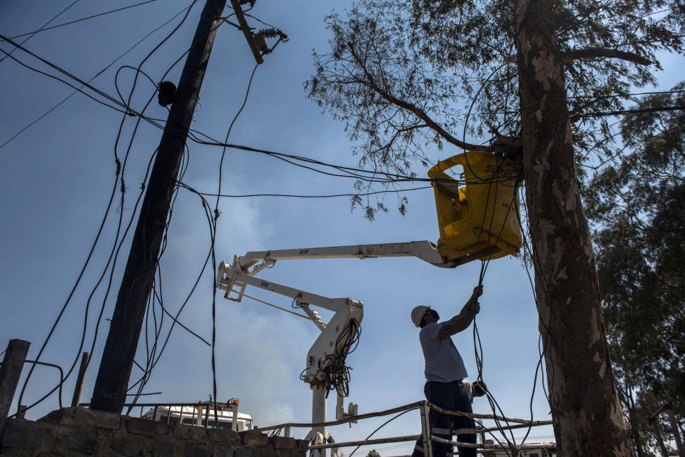 Image: Eskom workers cut illegal connections during a energy management and losses campaign in Gauteng, South Africa, on Sept. 29, 2020. (Alet Pretoriu / Gallo Images via Getty Images file)