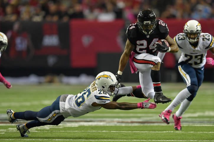 Oct 23, 2016; Atlanta, GA, USA; Atlanta Falcons running back Devonta Freeman (24) jumps over San Diego Chargers cornerback Casey Hayward (26) during the second half at the Georgia Dome. The Chargers defeated the Falcons 33-30 in overtime. Mandatory Credit: Dale Zanine-USA TODAY Sports