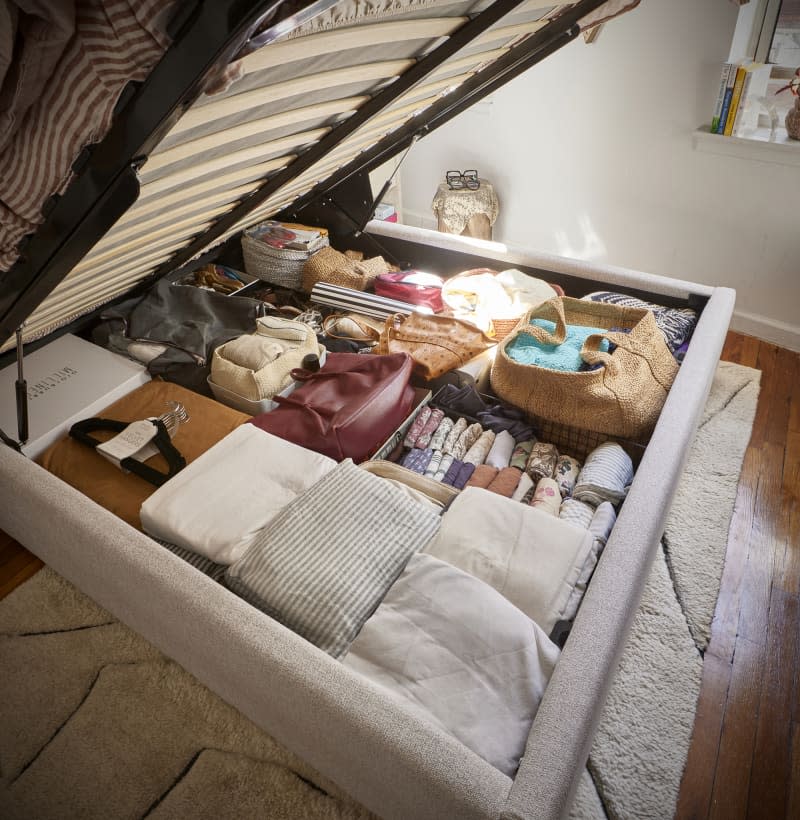 Mattress lifted to reveal storage in frame.