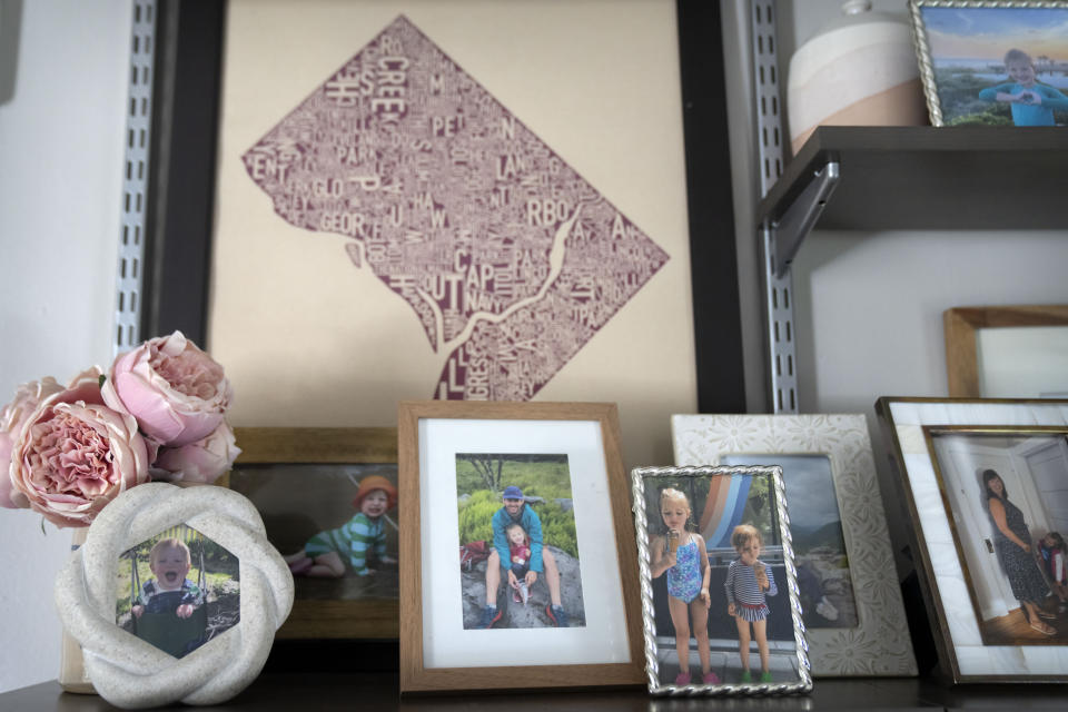Photos of Allie Hart, a 5-year-old girl who was struck and killed in 2021 by a driver while riding her bicycle in a crosswalk near her home, line a shelf at her family's home, Thursday, Sept. 14, 2023, in Washington. (AP Photo/Mark Schiefelbein)