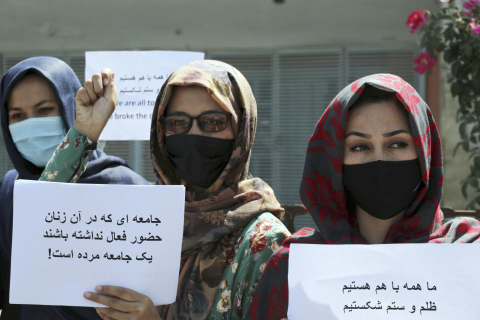 Women gather to demand their rights under the Taliban rule during a protest in Kabul, Afghanistan, Friday, Sept. 3, 2021. As the world watches intently for clues on how the Taliban will govern, their treatment of the media will be a key indicator, along with their policies toward women. When they ruled Afghanistan between 1996-2001, they enforced a harsh interpretation of Islam, barring girls and women from schools and public life, and brutally suppressing dissent. (AP Photo/Wali Sabawoon)