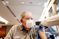 FILE - In this Jan. 12, 2021, file photo, Ken Towns receives a first dose of Pfizer-BioNTech COVID-19 vaccine from UC Davis Health in Sacramento, Calif. Uncertainty over the pace of federal COVID-19 vaccine allotments triggered anger and confusion Friday, Jan. 15, 2021, in some states where officials worried that expected shipments would not be forthcoming. (AP Photo/Noah Berger, Pool, File)