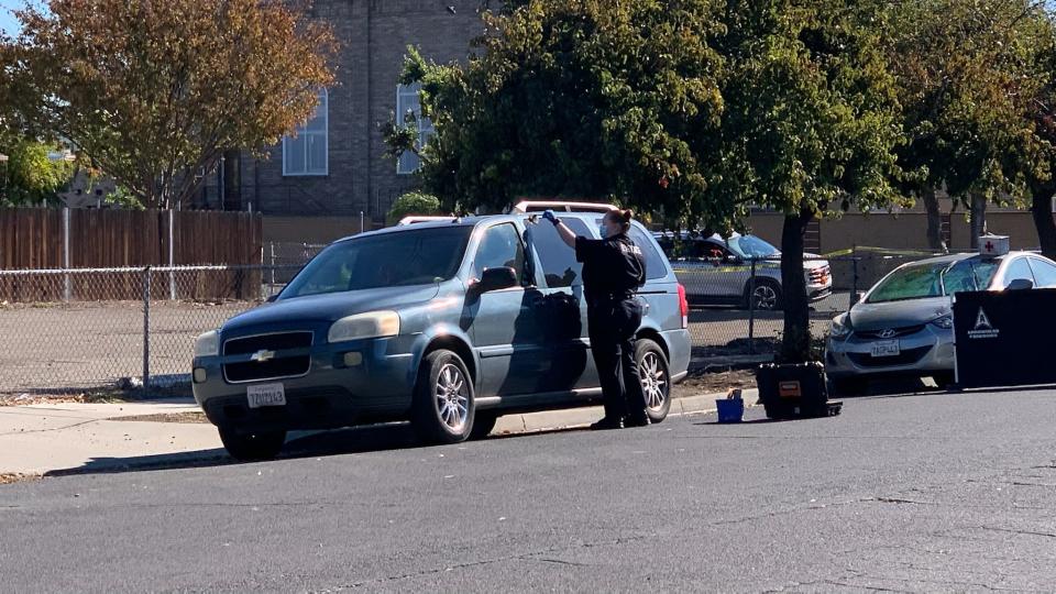 Police evidence technicians gather evidence where a woman was found fatally stabbed inside a vehicle on Sikh Temple Street in south Stockton