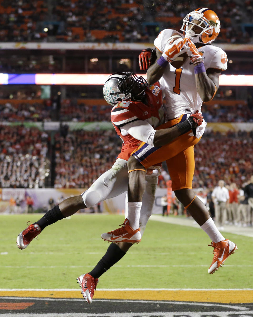 Clemson wide receiver Martavis Bryant (1) makes a catch for a touchdown as Ohio State cornerback Armani Reeves defends during the first half of the Orange Bowl NCAA college football game, Friday, Jan. 3, 2014, in Miami Gardens, Fla. (AP Photo/Wilfredo Lee)